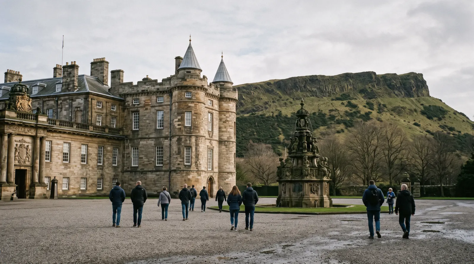 The west front and turreted towers of the Palace of Holyroodhouse with the abbey ruins behind and Salisbury Crags rising above, Edinburgh