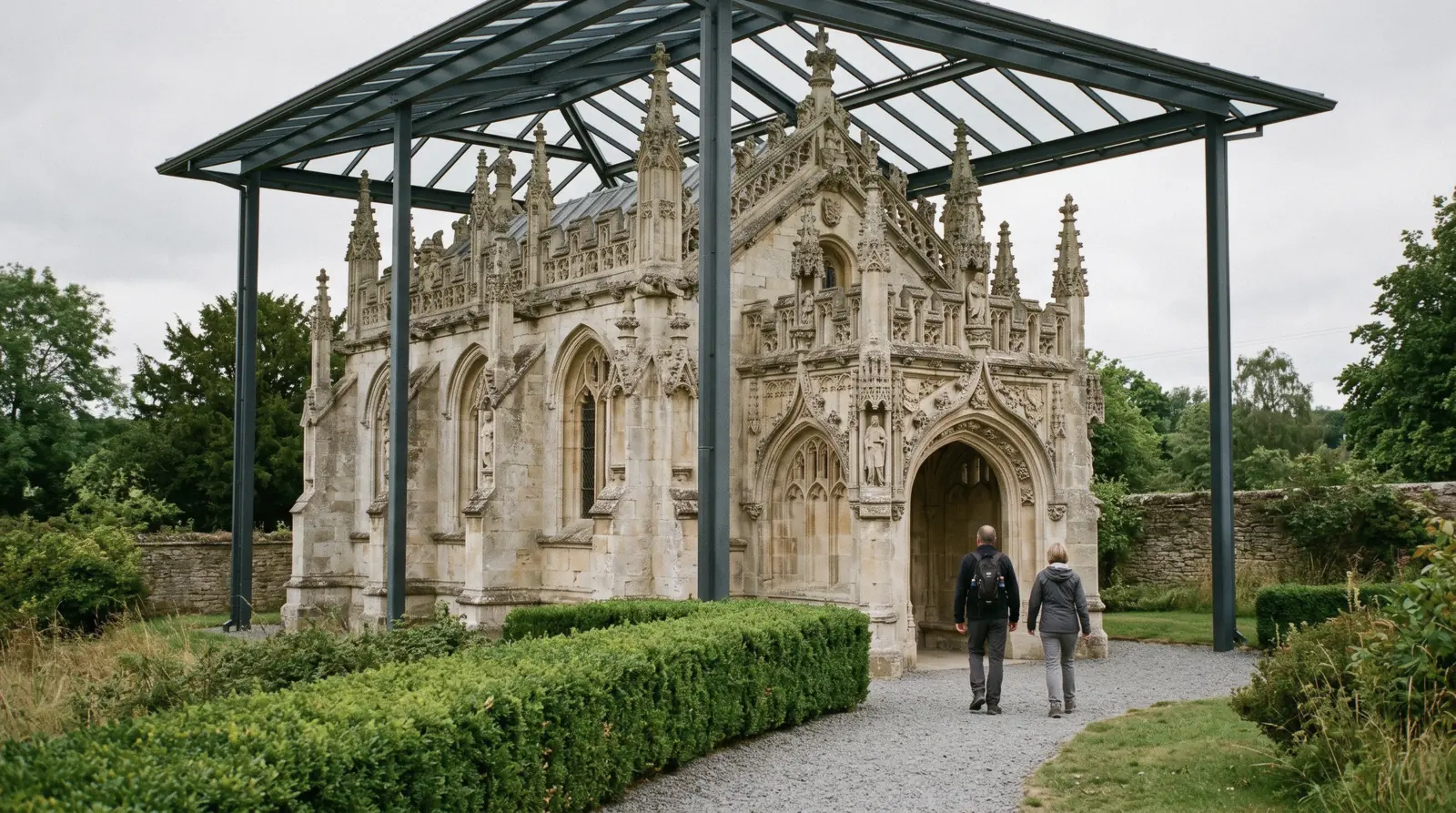 The carved stone exterior and flying buttresses of Rosslyn Chapel at Roslin, Midlothian, seen from the visitor path on a bright afternoon