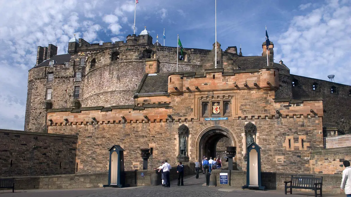 Guide leading visitors across the Edinburgh Castle esplanade on a guided castle walking tour