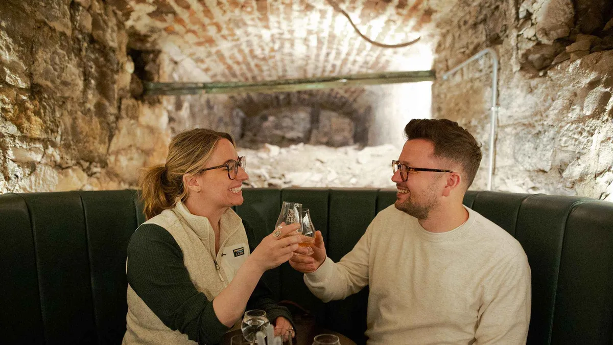 Whisky flight served by candlelight in an underground vault at The Lost Close Scotch whisky tasting in Edinburgh