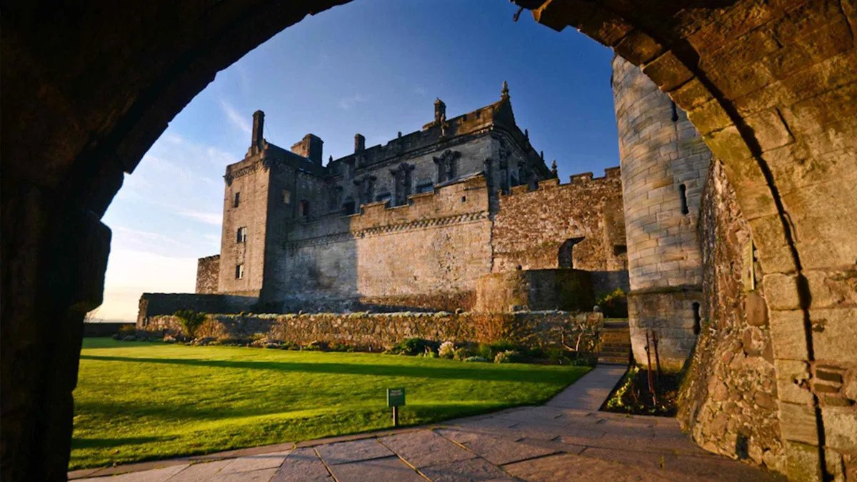 Guided group inside the royal palace courtyard at Stirling Castle on a train day trip from Edinburgh